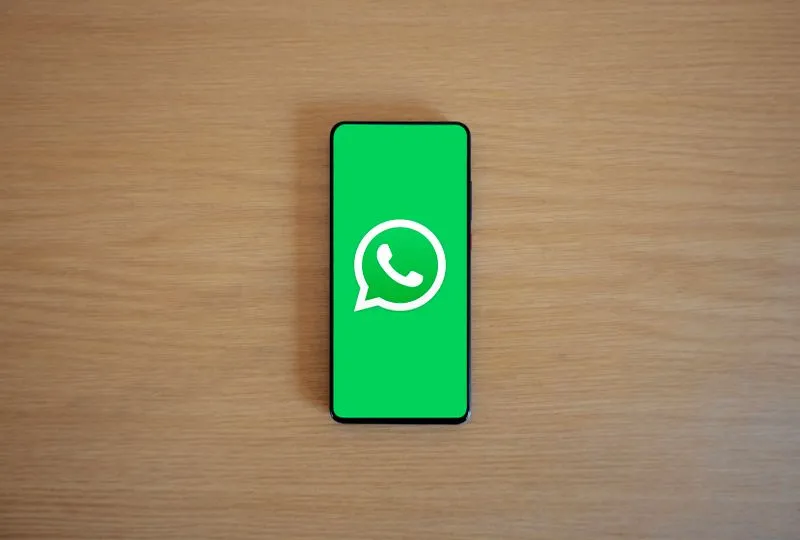 Person sending a WhatsApp message on a smartphone