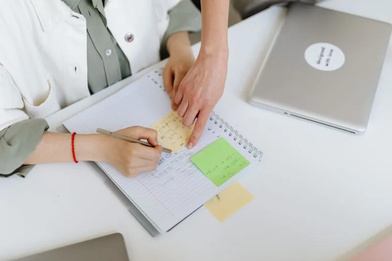 A skills list beside a laptop