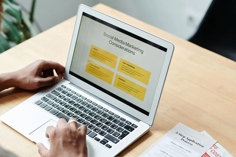 Digital marketer working across campaigns on a laptop