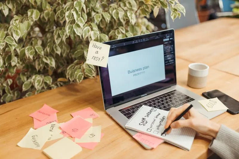 Planning a tool stack with a checklist on a laptop and notepad