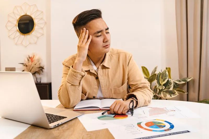 Business owner reviewing a disappointing marketing report at a desk