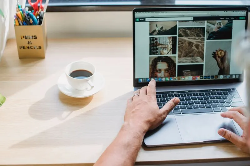 Web designer working on a website mockup on a laptop screen