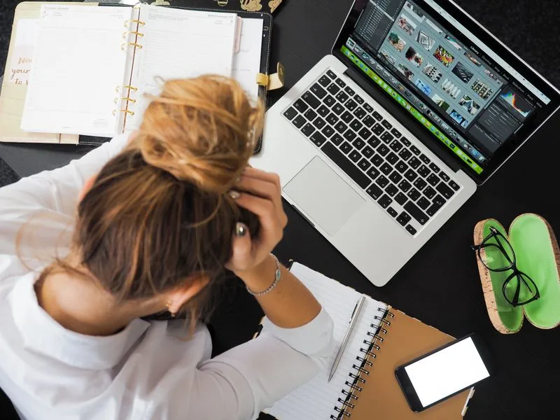 Person surrounded by multiple phone screens