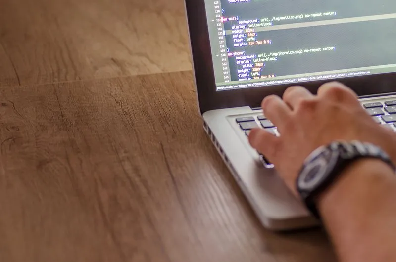 Web developer building a website on a laptop